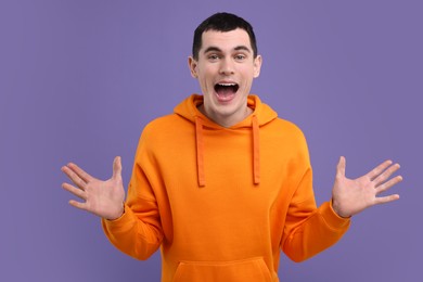 Photo of Portrait of surprised man on purple background