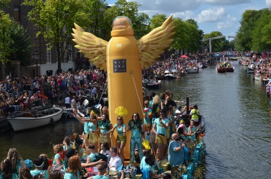 AMSTERDAM, NETHERLANDS - AUGUST 06, 2022: Many people in boats at LGBT pride parade on river