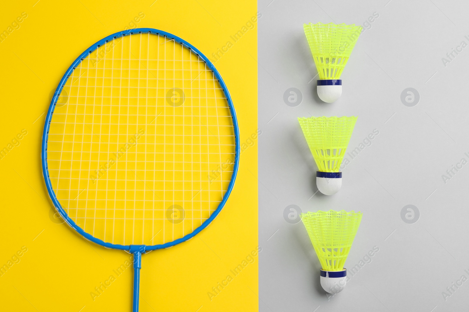 Photo of Badminton racket and shuttlecocks on color background, flat lay