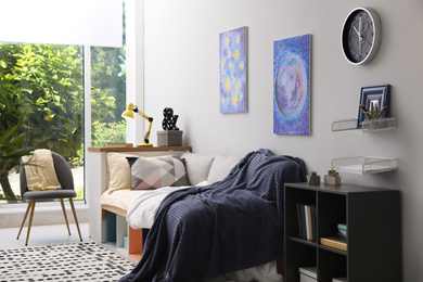 Photo of Modern teenager's room interior with comfortable bed and stylish design elements