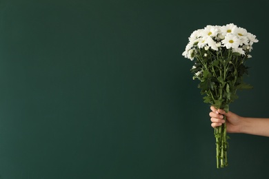 Photo of Woman holding beautiful bouquet near green chalkboard, space for text. Happy Teacher's Day