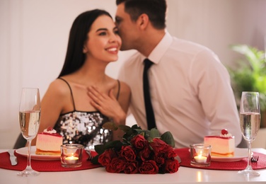 Happy couple having romantic dinner on Valentine's day in restaurant