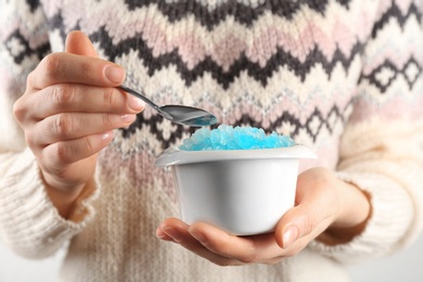 Photo of Woman eating tasty snow ice cream dessert, closeup