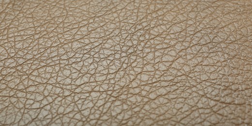 Photo of Texture of beige leather as background, closeup