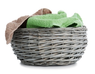 Photo of Wicker basket with towels isolated on white