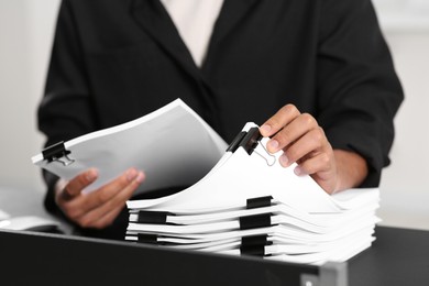 Man working with documents at grey table in office, closeup
