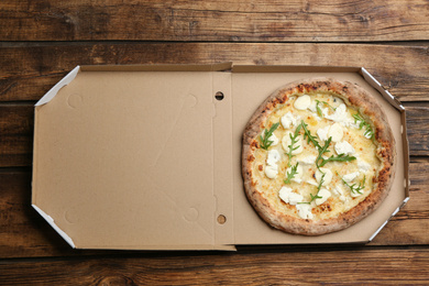 Photo of Tasty cheese pizza on wooden table, top view. Space for text