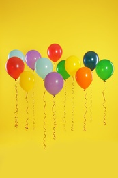 Bright balloons on color background. Celebration time