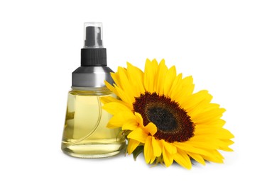 Photo of Spray bottle with cooking oil and sunflower on white background