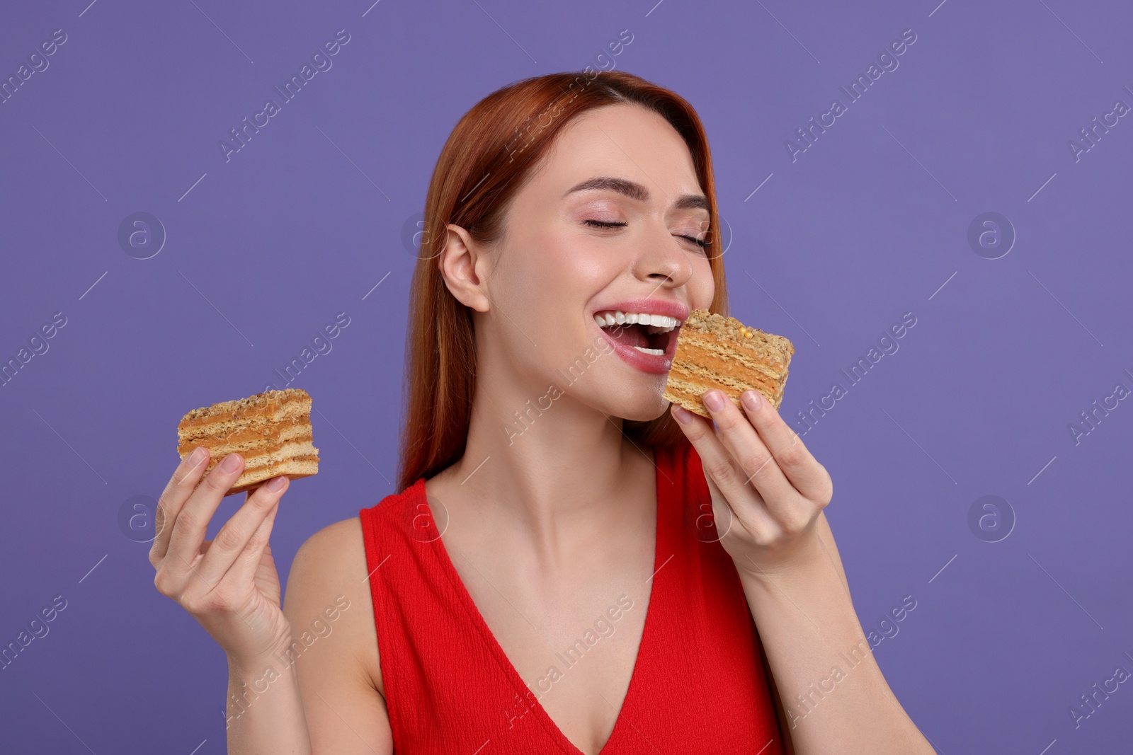 Photo of Young woman eating pieces of tasty cake on purple background