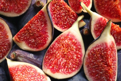 Fresh ripe fig slices as background, top view. Tropical fruit