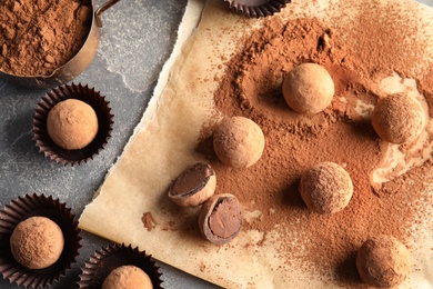 Photo of Flat lay composition with chocolate truffles on grey background