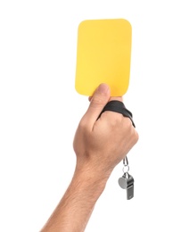 Man holding yellow card and whistle on white background, closeup of hand