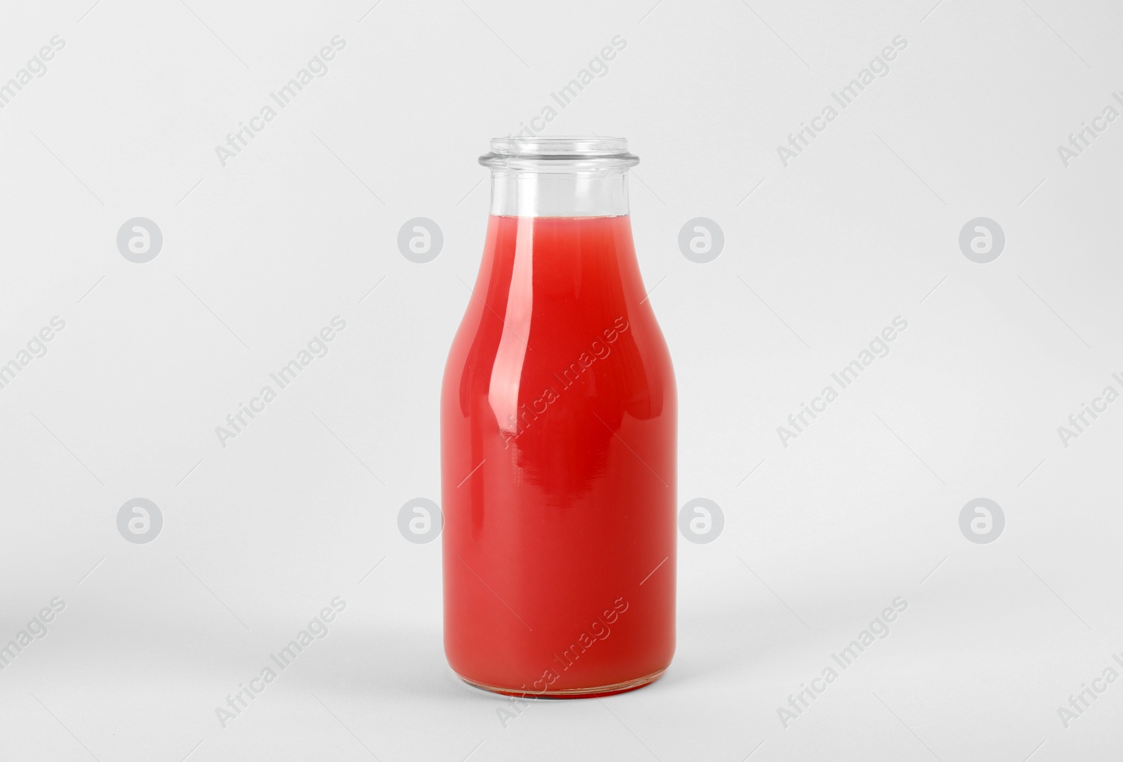 Photo of Bottle with delicious fresh juice on white background