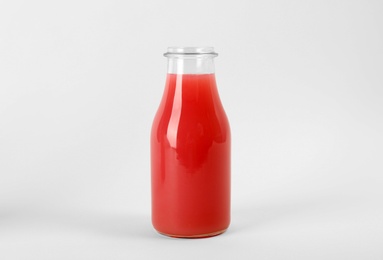 Photo of Bottle with delicious fresh juice on white background