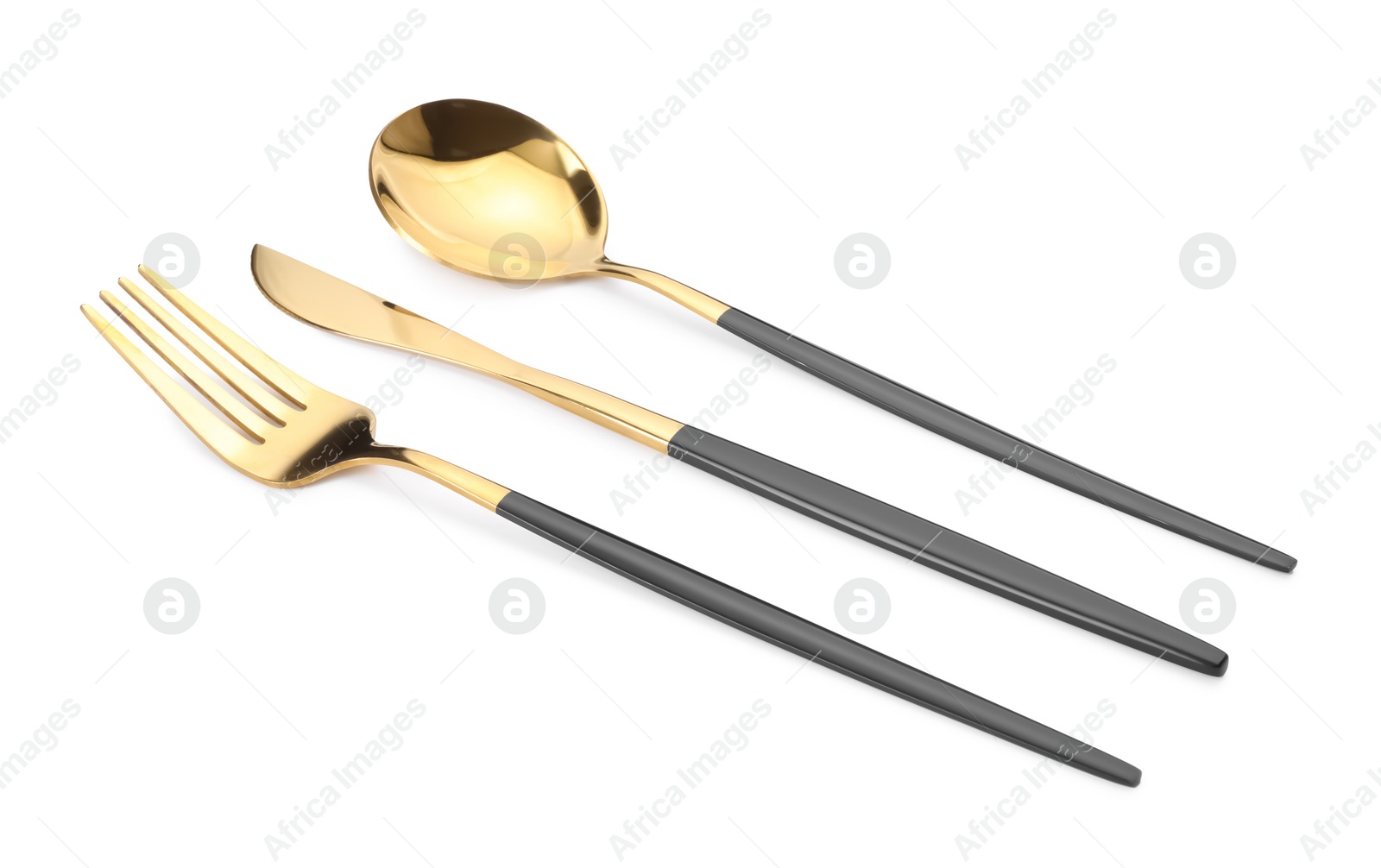 Shiny golden fork, knife and spoon isolated on white. Luxury cutlery set Photo of Shiny golden fork, knife and spoon isolated on white. Luxury cutlery set