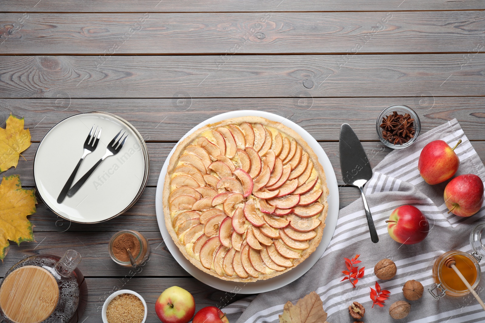 Photo of Flat lay composition with freshly baked delicious apple pie on wooden table. Space for text