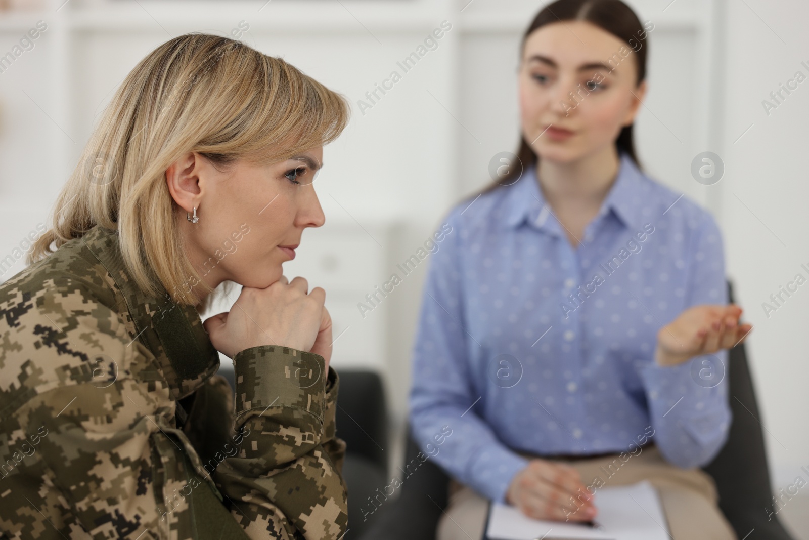 Photo of Psychotherapist working with military woman in office