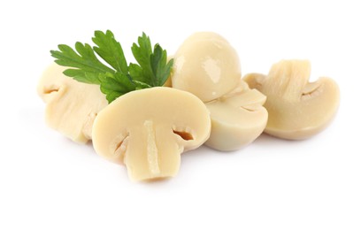 Photo of Cut marinated mushrooms and parsley isolated on white