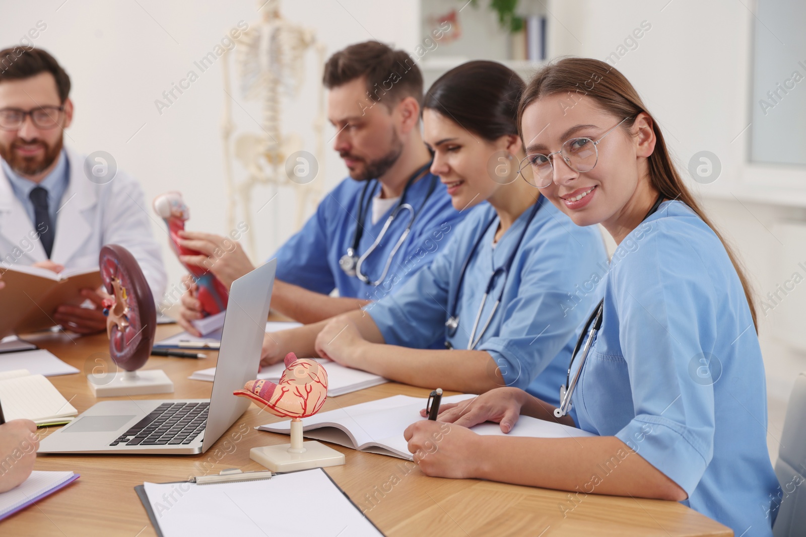 Photo of Medical students in uniforms studying at university