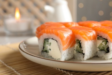 Tasty sushi rolls served on table, closeup