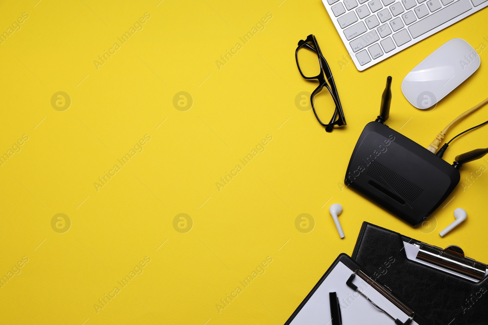 Photo of Flat lay composition with modern Wi-Fi router on yellow background, space for text