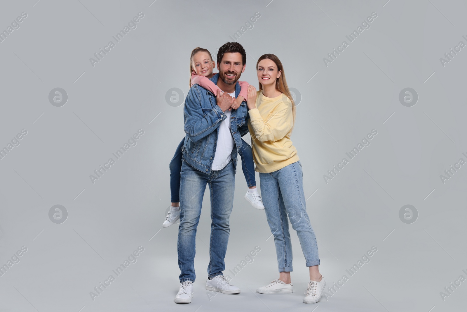 Photo of Portrait of happy family on light grey background