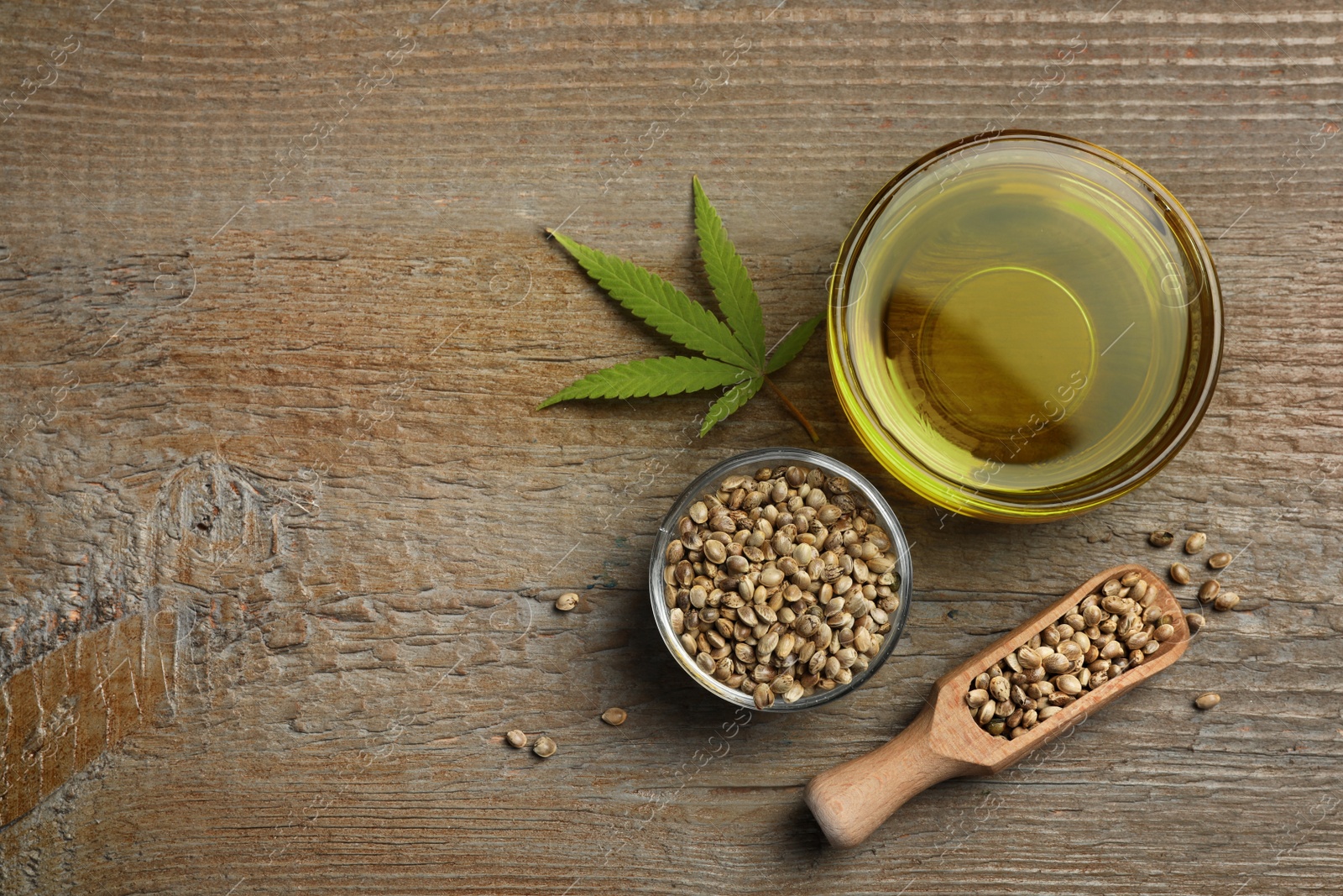 Photo of Flat lay composition with hemp oil on wooden table. Space for text