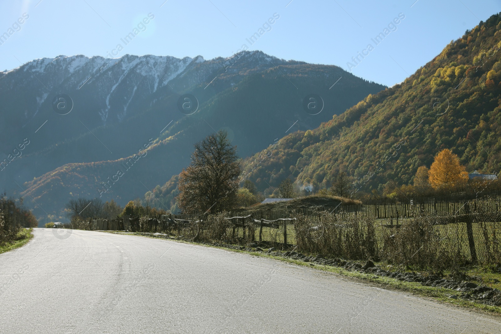 Photo of View of empty asphalt highway in mountains on sunny day. Road trip