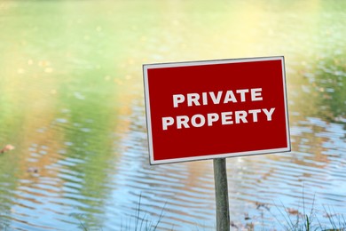 Image of Red sign with text Private Property near lake