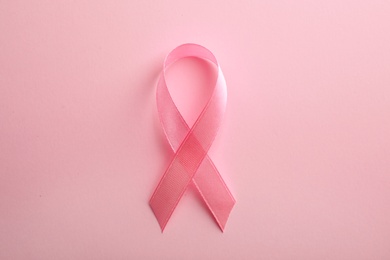 Pink ribbon on color background, top view. Breast cancer awareness concept