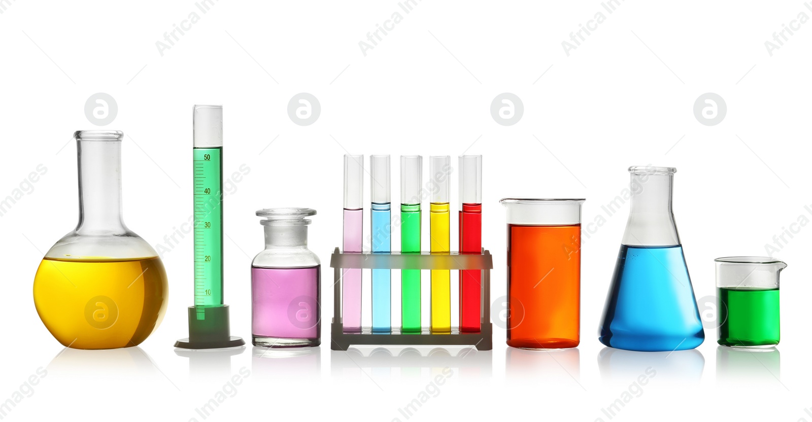 Photo of Laboratory glassware with colorful liquids on white background