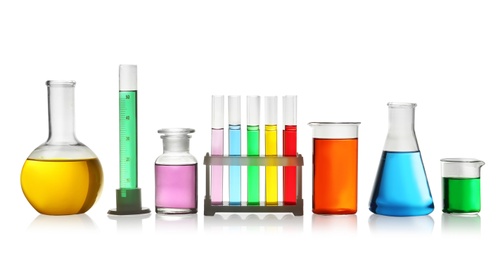 Laboratory glassware with colorful liquids on white background