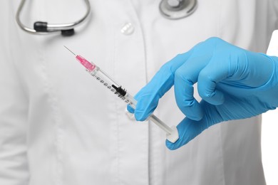 Photo of Doctor holding medical syringe with needle, closeup view