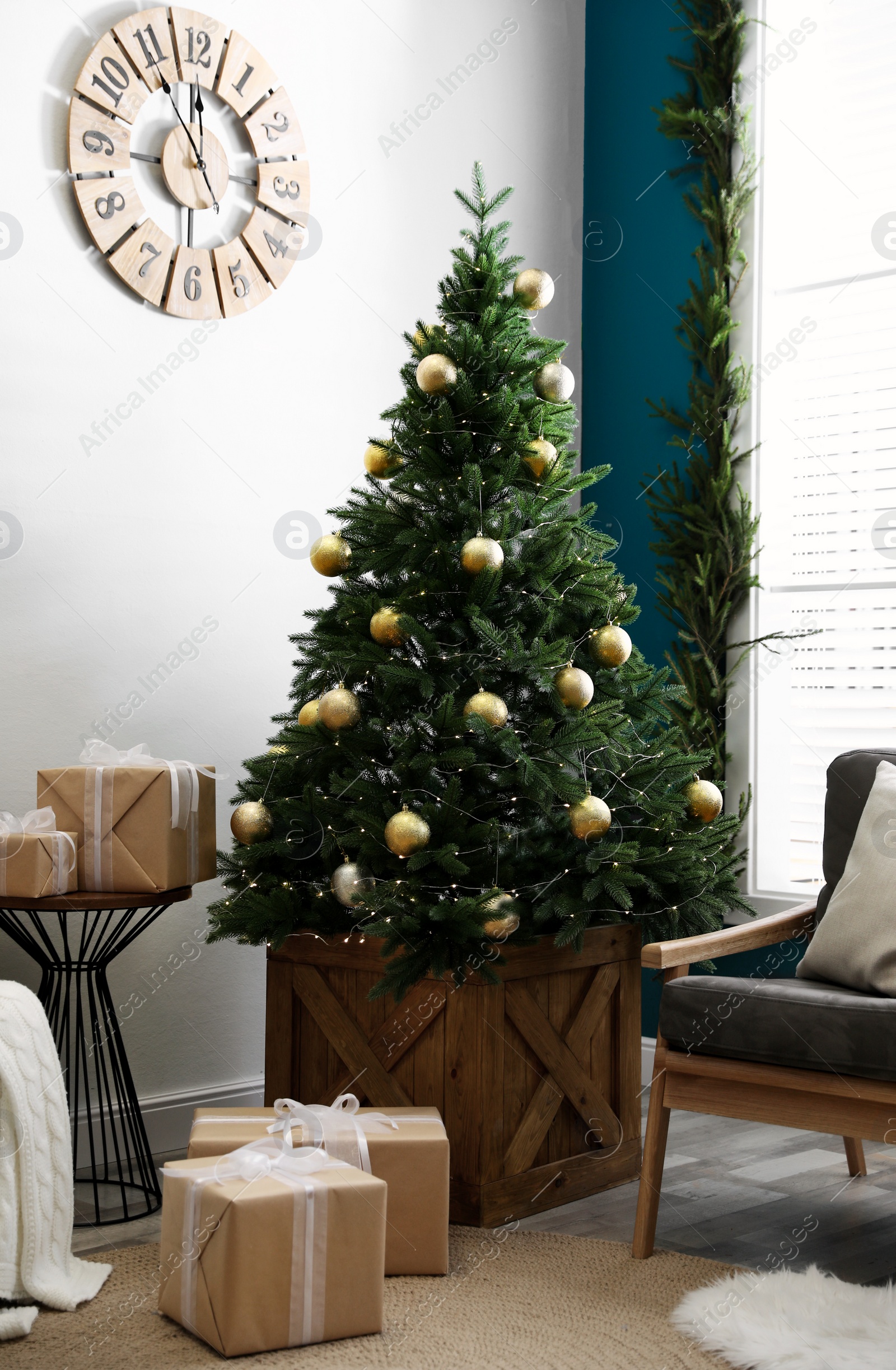 Photo of Stylish interior with decorated Christmas tree in living room