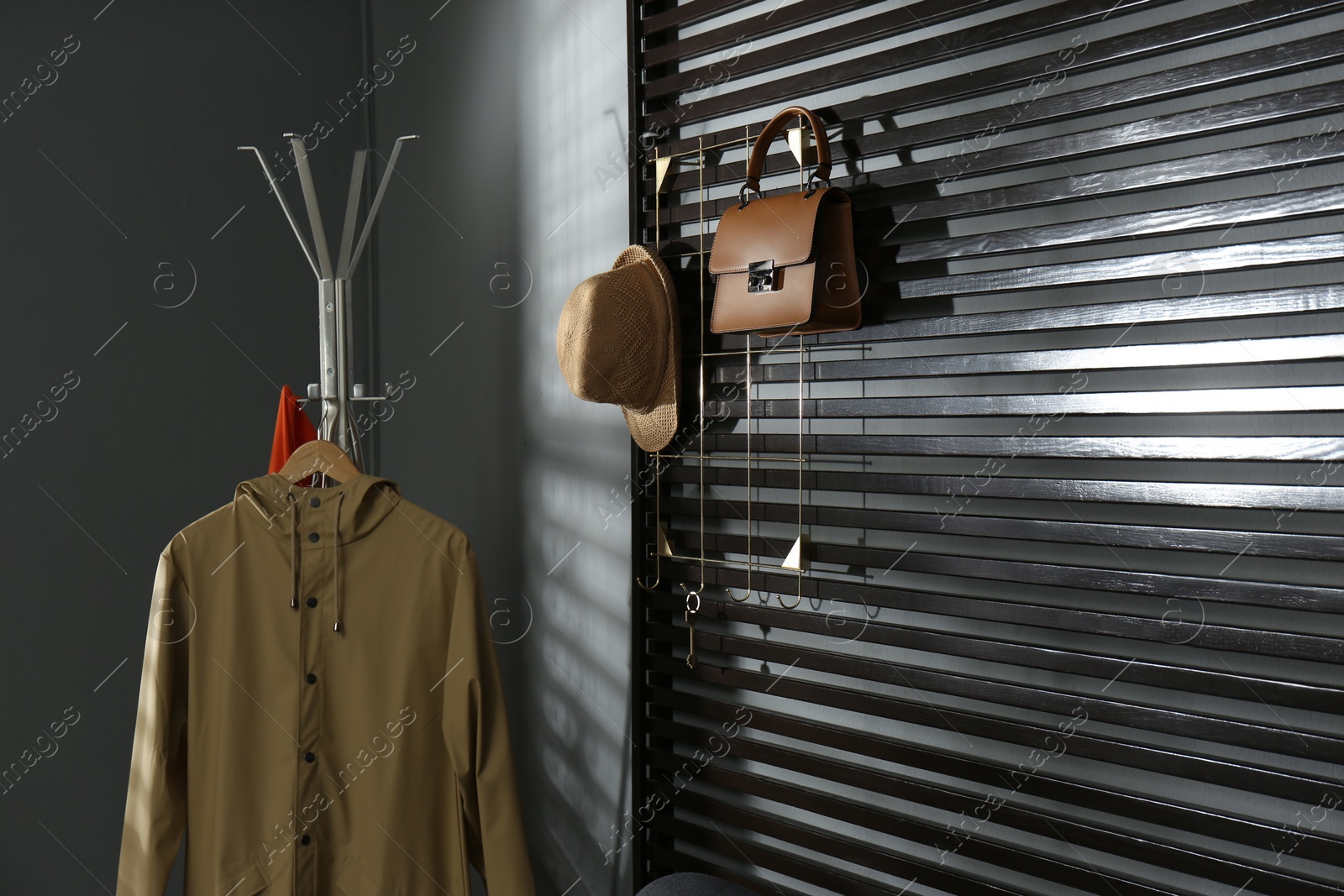 Photo of Rack with clothes and accessories in modern hallway