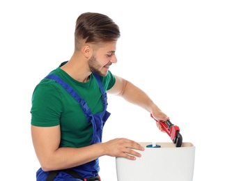 Photo of Young man working with toilet tank, isolated on white