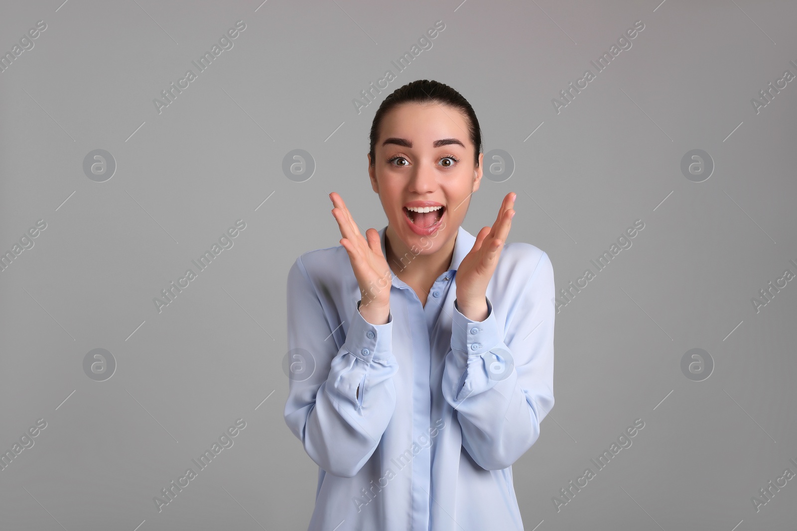 Photo of Portrait of emotional young woman on light grey background. Personality concept