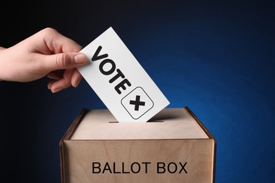 Image of Woman putting paper with word Vote and tick into ballot box on dark blue background