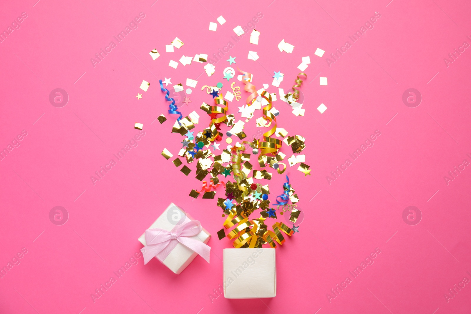 Photo of Box with bright confetti on pink background, flat lay