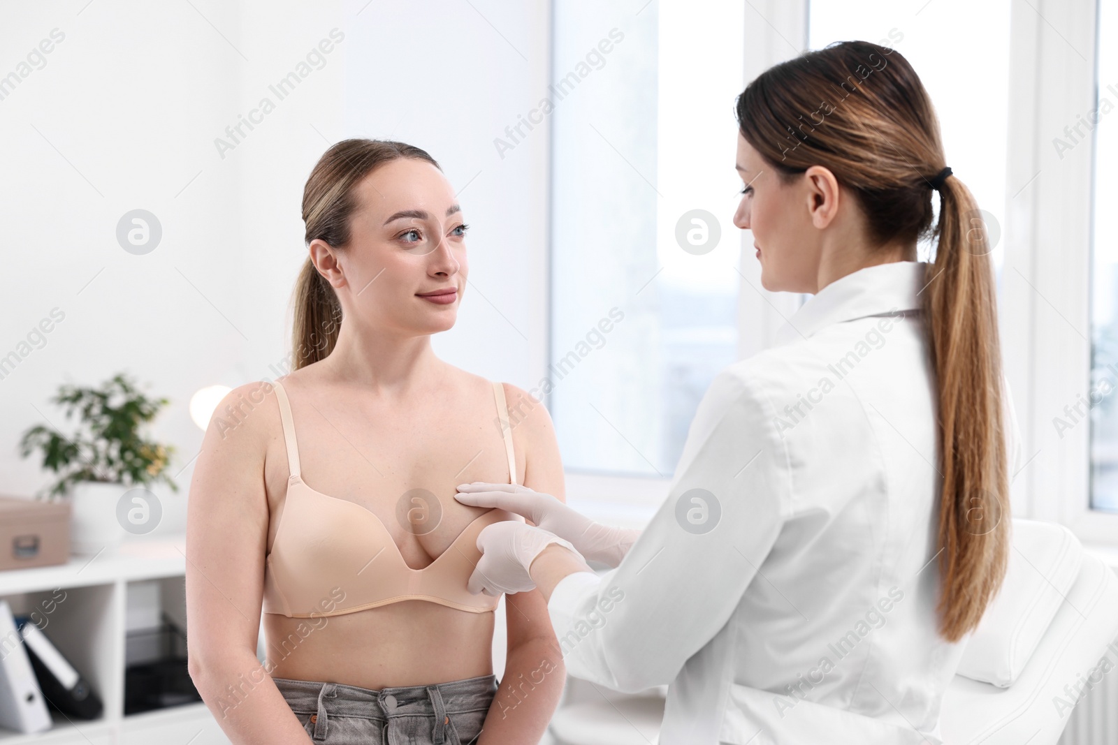 Photo of Mammologist checking young woman's breast in hospital