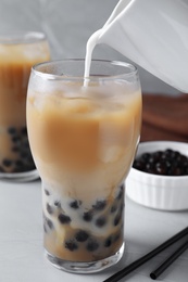 Preparing bubble milk tea with tapioca balls on table