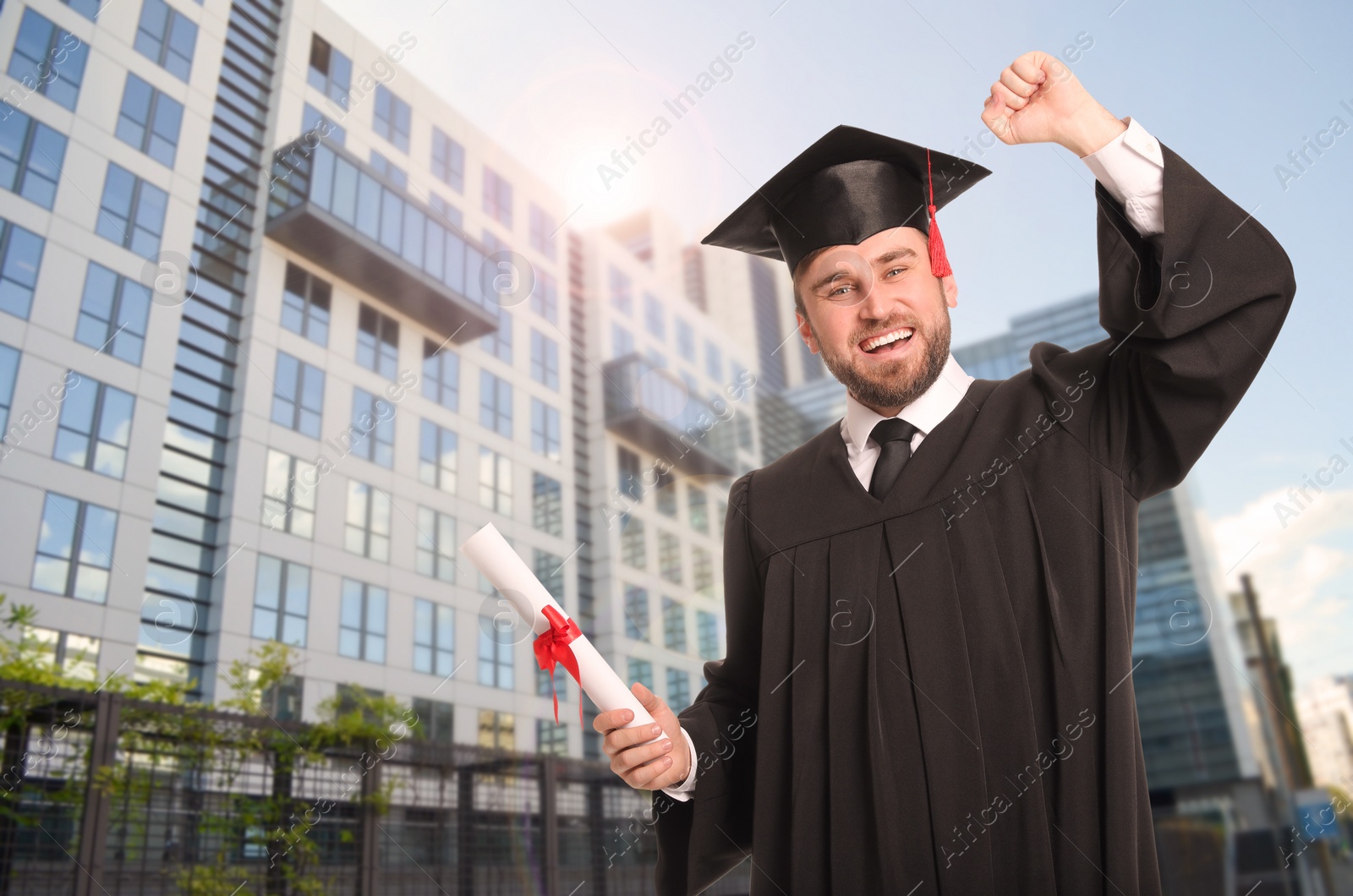 Image of Happy student with graduation hat and diploma outdoors