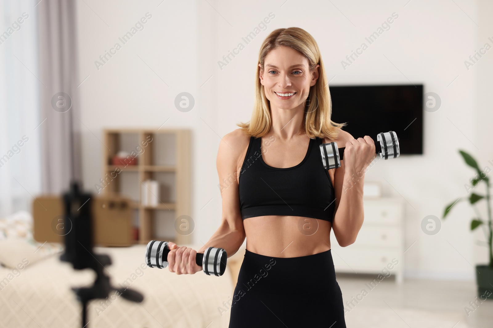 Photo of Fitness trainer recording online classes at home