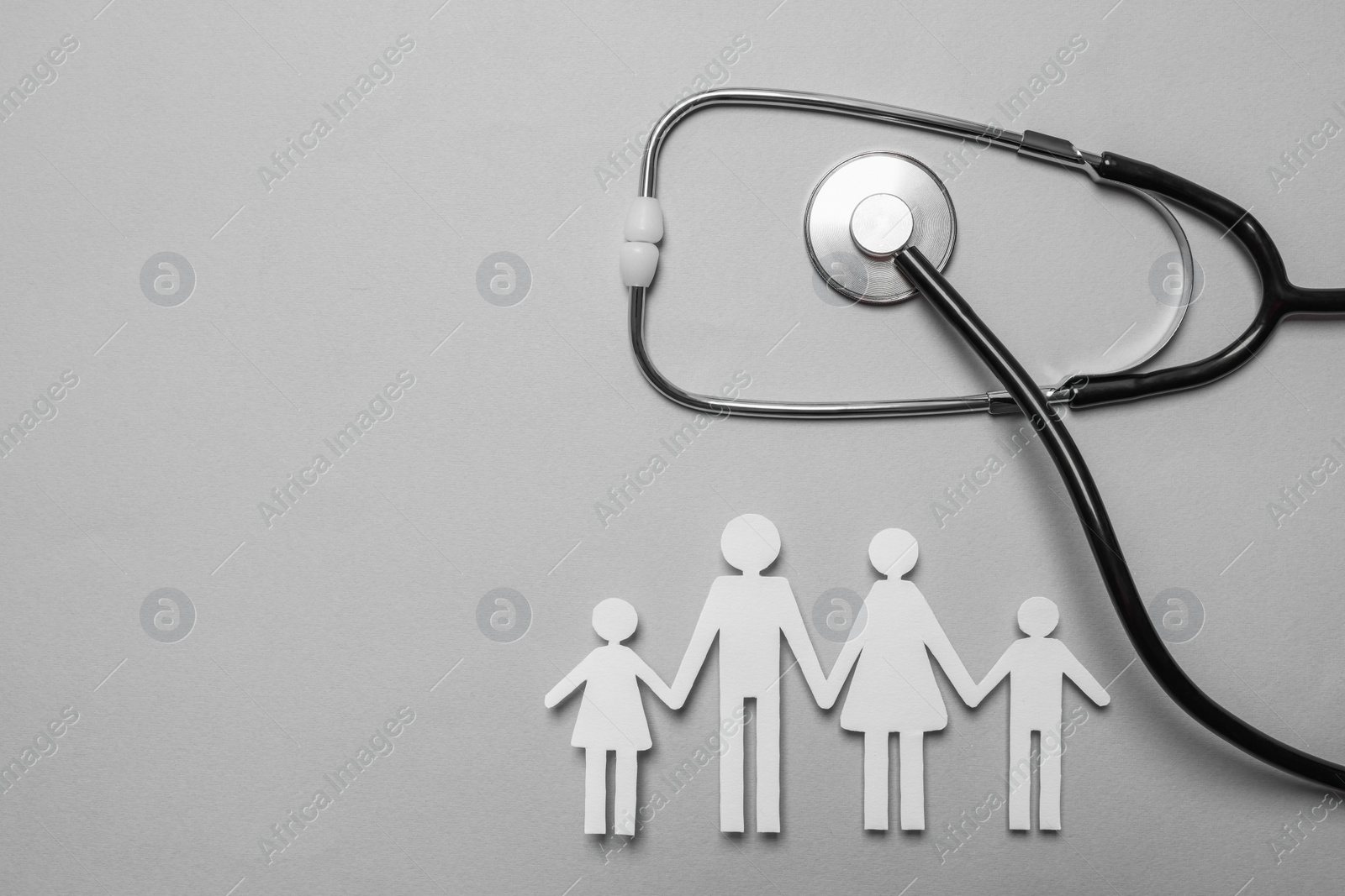 Photo of Paper family cutout, stethoscope and space for text on grey background, flat lay. Insurance concept