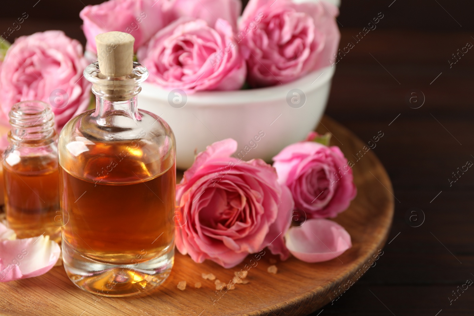 Photo of Composition with aroma oil on wooden table, closeup