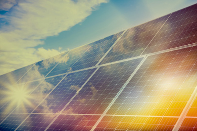 Image of Sunlit solar panels against blue sky. Alternative energy source