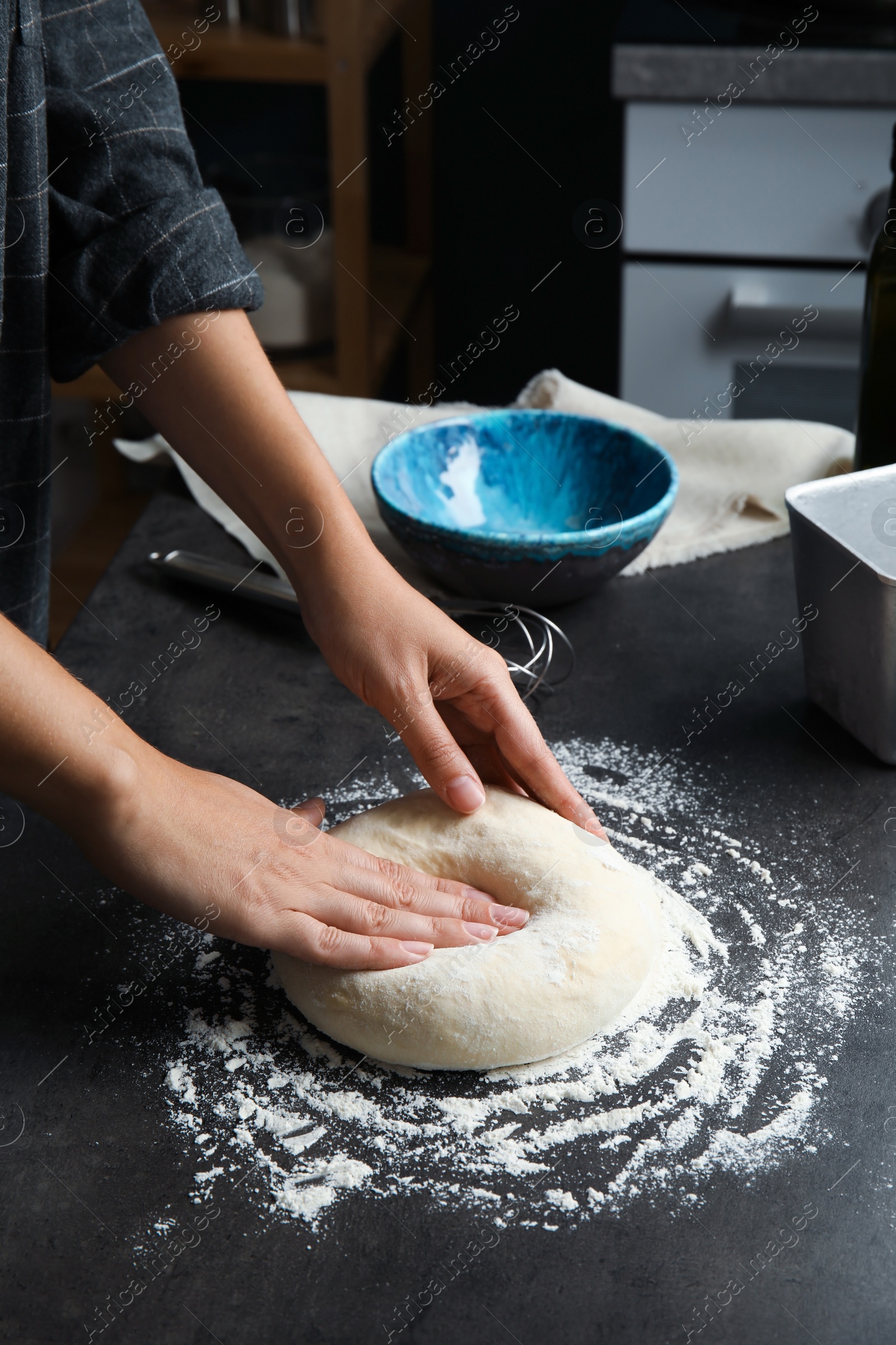 Photo of Woman kneading dough for pastry on table