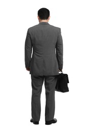 Businessman with briefcase posing on white background, back view