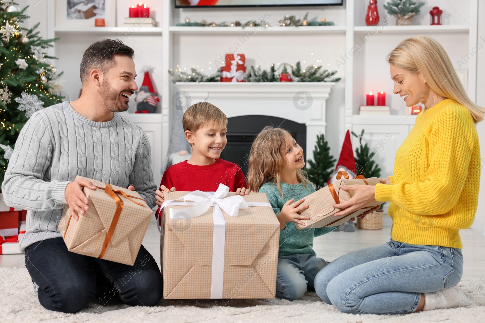 Photo of Happy family with Christmas gifts at home